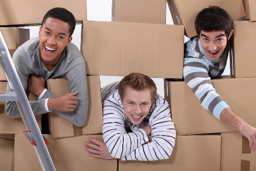 Packed moving boxes and furniture ready for local transport