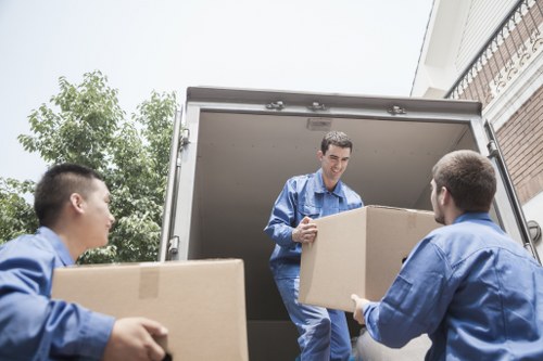 Furniture and boxes being loaded into a van for a Plaistow collection