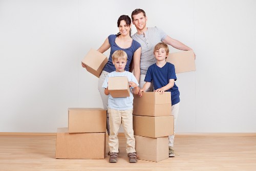 Packed household boxes and furniture prepared for a home move in Plaistow