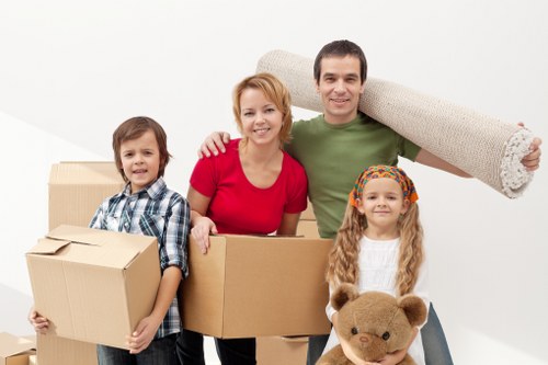 Professional movers handling furniture in a Plaistow home