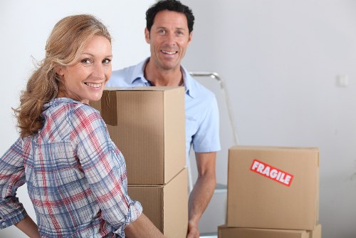 Professional movers carrying furniture during a local removals job