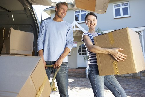 Mover loading household items carefully into a van